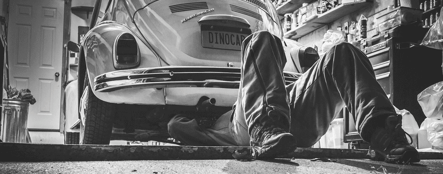 A man working on a car who needs tool box financing.