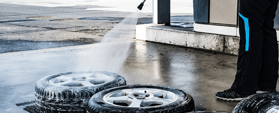 A man using a pressure washer after financing.