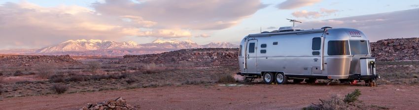A camper parked int he desert.
