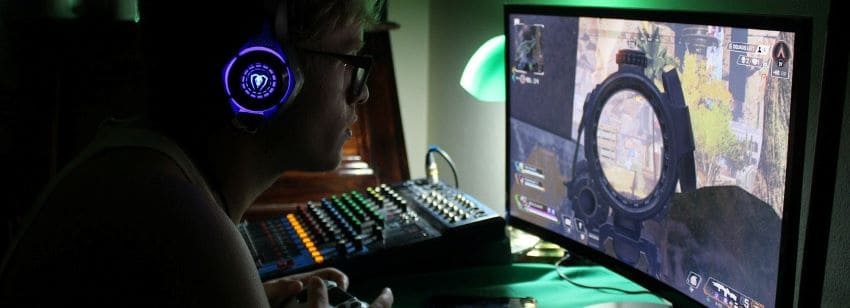 A man playing a gaming desktop purchased with financing.