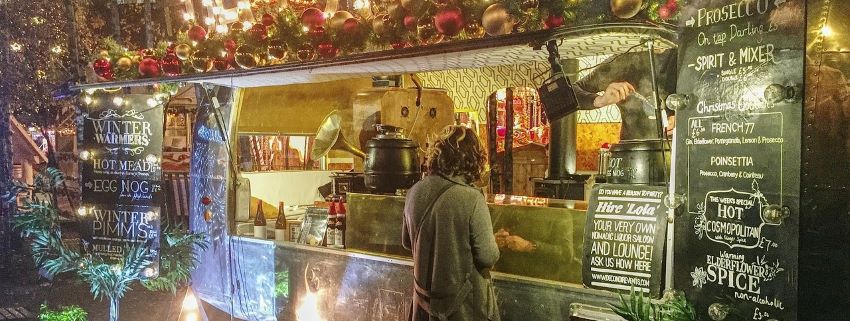 Woman ordering from food trailer.