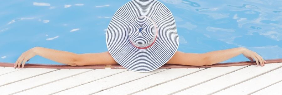 A woman enjoying an above gound pool purchased with financing.