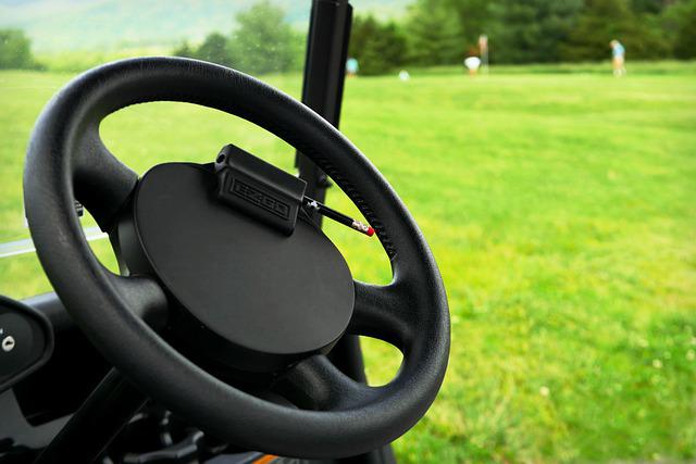 Golfer using a golf cart.