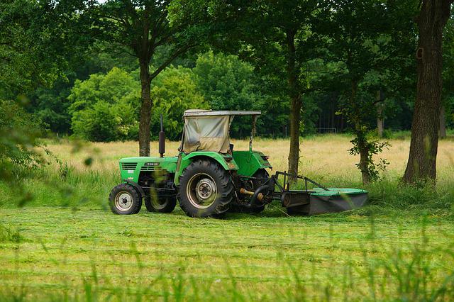 Commercial mower cutting a field.