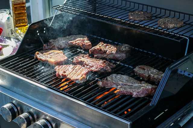 A gas grill cooking meat.