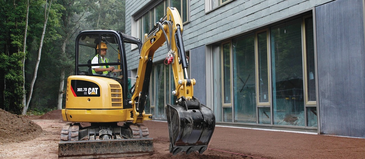 Man using a mini excavator purchased with bad credit financing.