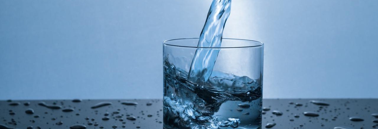 Well water being poured into a glass.